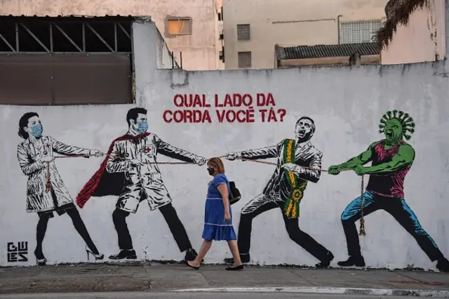 A woman passes by a graffiti