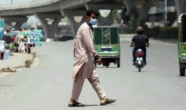 A Pakistani pedestrian wearing a face mask