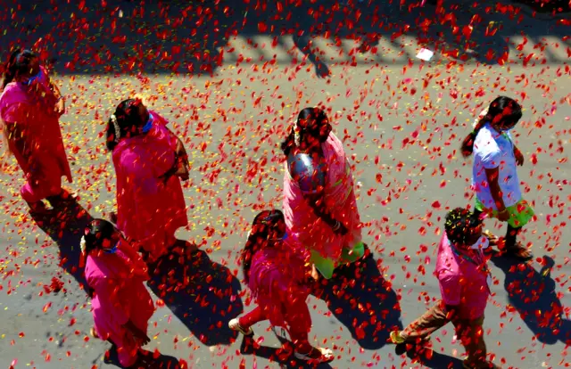 Indian medical staff after rose petals are thrown to pay tribute to health workers