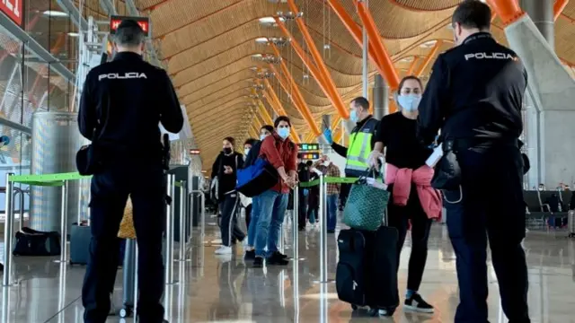 File photo of passengers being checked at Madrid airport