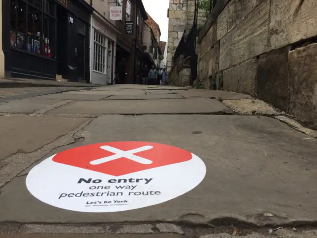 A sign on the floor in the Shambles