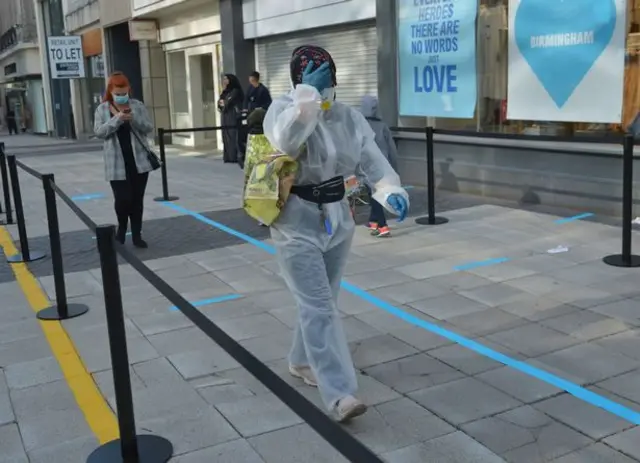 A shopper wearing full PPE