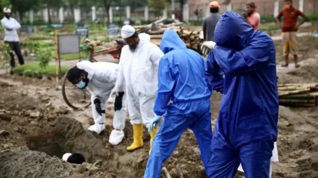 Workers at a mass grave in Bangladesh