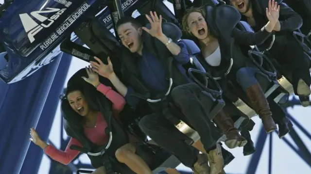 People on a rollercoaster