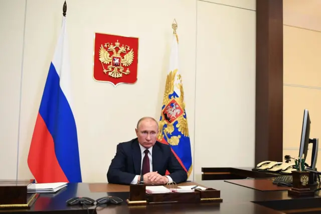 Russian President Vladimir Putin attends a meeting with Defence Minister via teleconference call at Novo-Ogaryovo state residence,