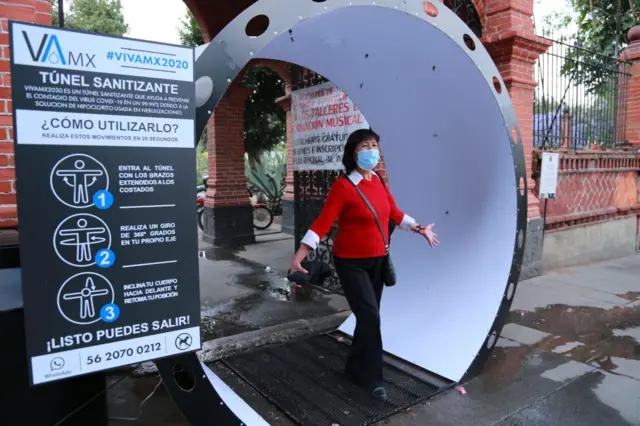 A person walks through of a sanitizing tunnel as a preventive measure against the spread of Coronavirus on April 6 ,2020 in Mexico City, Mexico