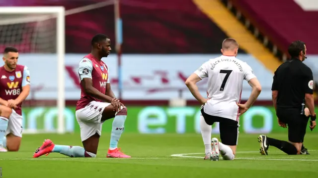 Keinan Davis of Aston Villa and John Lundstram of Sheffield United take a knee in support of the Black Lives Matter movement