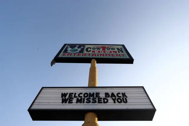 A sign at a bowling alley in Texas welcomes back customers