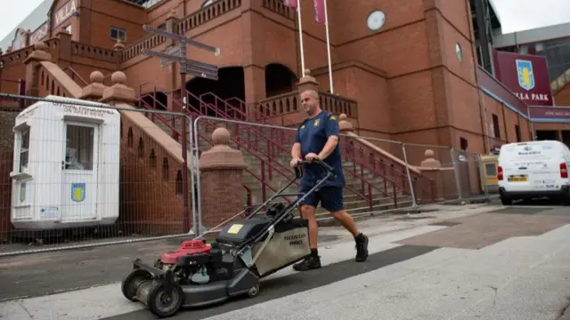 Ground staff at Villa Park, Birmingham, before the Premier League restart