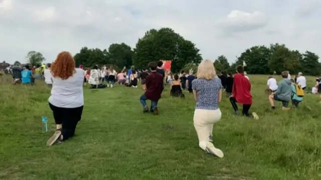 People kneeling at the protest