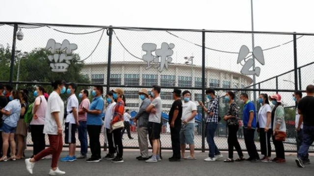 People standing in line wearing face masks