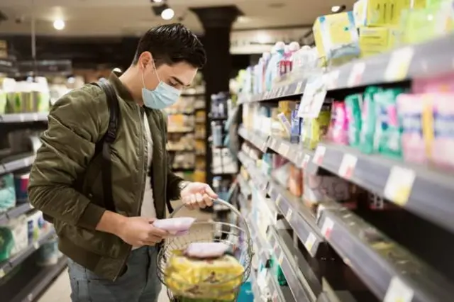 A man in a mask in a shop