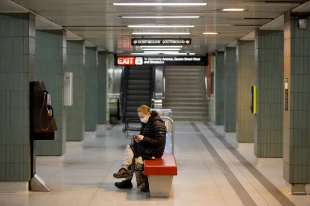 A woman is seen wearing a mask in the subway during morning commuting hours as Toronto copes with a shutdown due to the Coronavirus, on April 1, 2020 in Toronto, Canada