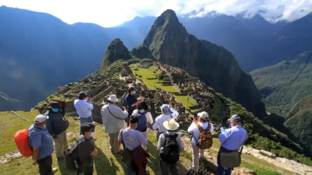 People with face mask in Machu Picchu