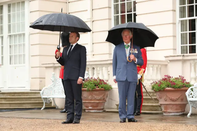 Mr Macron stands with Prince Charles