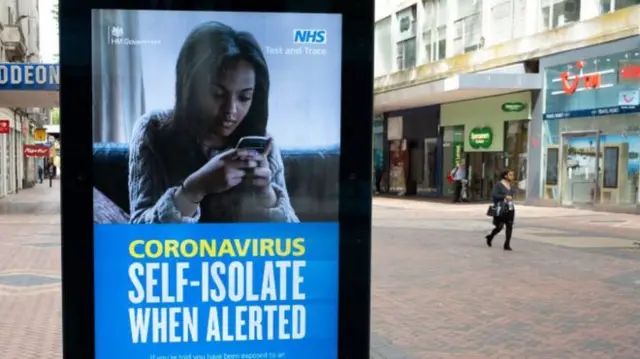 An advert in the street for the NHS' test and trace system