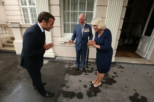 The group avoiding shaking hands with Macron returning their namaste gestures