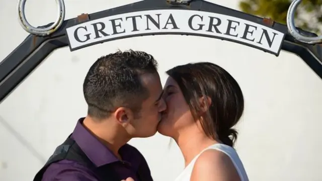 A bride and groom kissing at Gretna Green