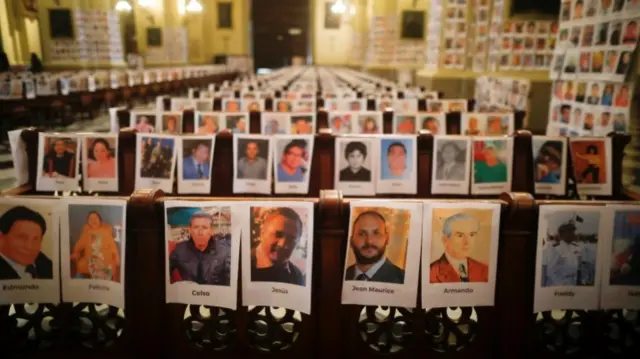 Photographs of virus victims inside a church building