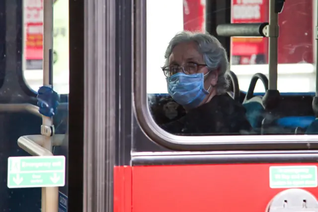 Woman in mask on bus