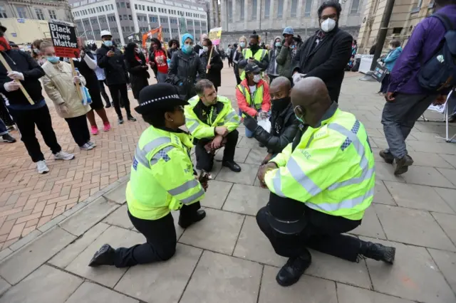 Officers taking the knee