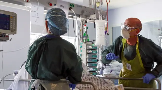 Staff treat a coronavirus patient in an ICU at Frimley Park Hospital in Frimley, southwest England