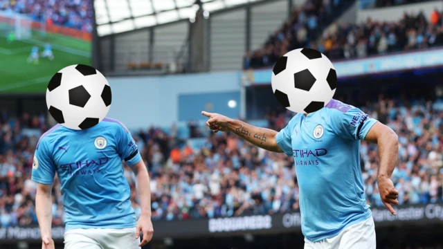 Two Manchester City players hidden by a football