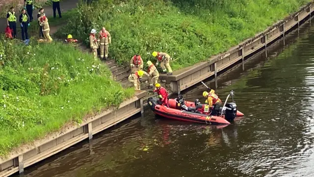 Firefighters in a boat on the Ouse