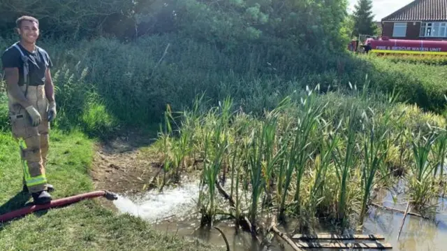 Firefighter at pond