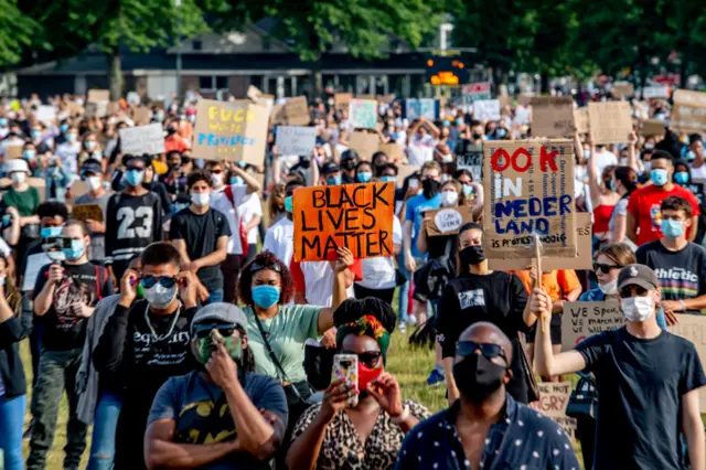 Thousand of protests are seen wearing facemasks at Malieveld in The Hague with protest placards during the Black Lives Matter protest.