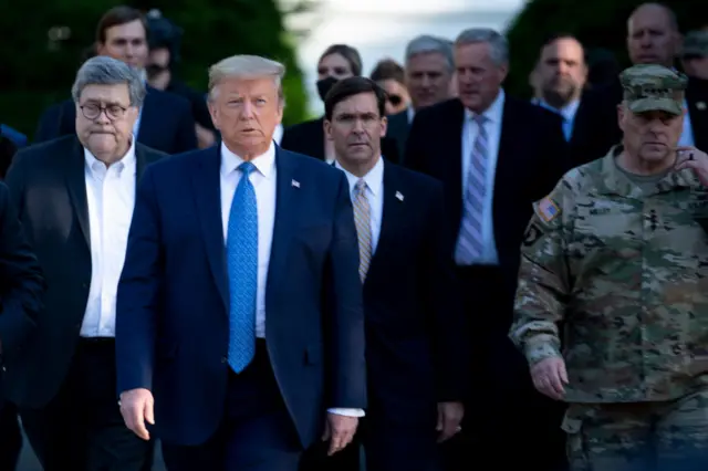 US President Donald Trump walks with US Attorney General William Barr (L), US Secretary of Defense Mark T. Esper (C), Chairman of the Joint Chiefs of Staff Mark A. Milley (R)