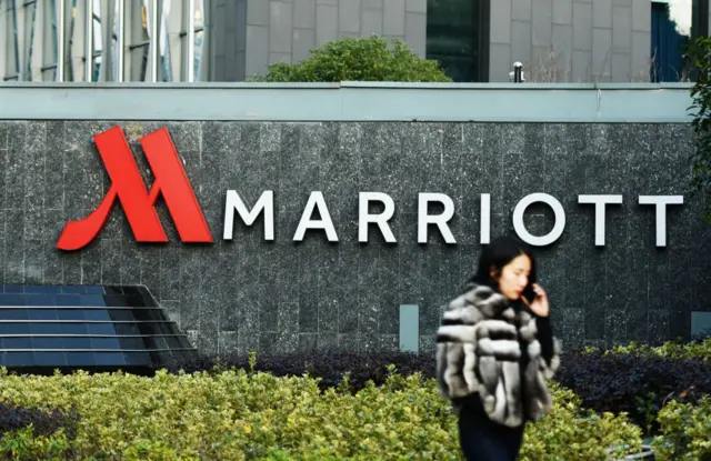 A woman walking past Marriott signage in Hangzhou in China's Zhejiang province.