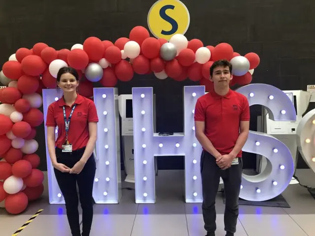 Carly Horne and Ben Gebhardt are volunteering at the Give and Go desks at a Glasgow hospital