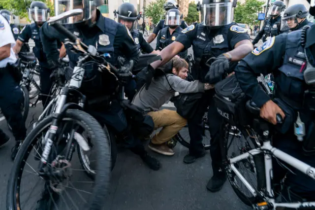 A protester clashes with police