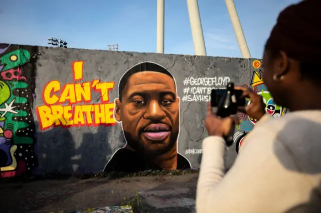 A mural of George Floyd painted by the artist eme_freethinker on a wall at Mauerpark in Berlin