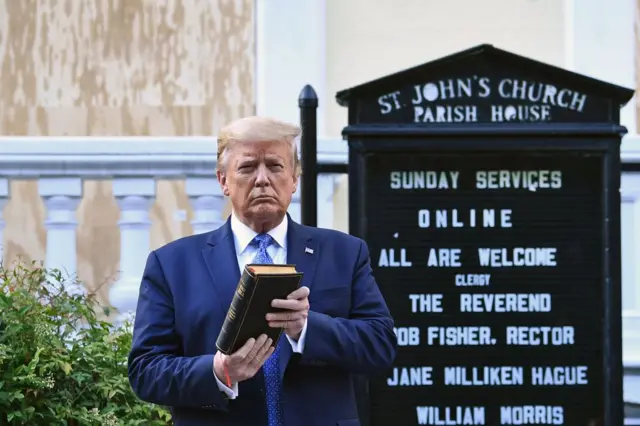 US President Donald Trump holds up a Bible outside of St John's Episcopal church