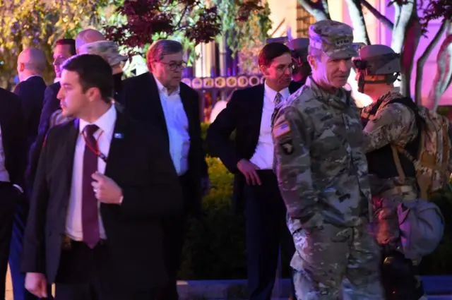 US Attorney General William Barr (centre-left) and other officials are escorted by US service personnel as they walk in central Washington DC during a curfew. Photo: 1 June 2020