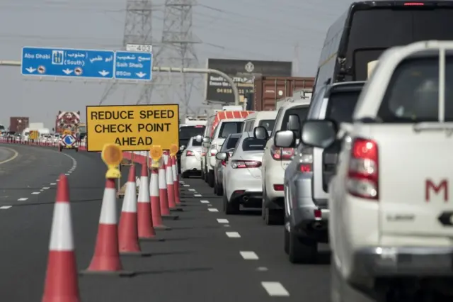 Cars queue before a security checkpoint on the E11 highway