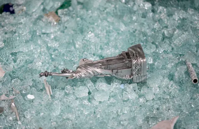 A Statue of Liberty statue lies in shattered glass at a souvenir store in Manhattan