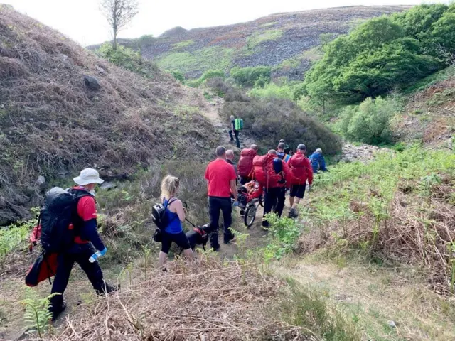 Volunteers walk through the Peak District