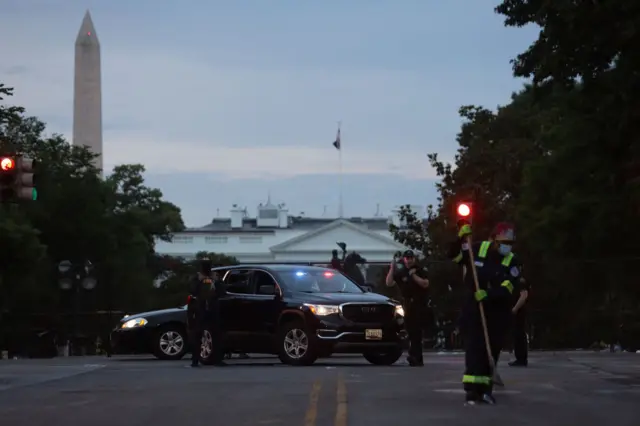 Members of the U.S. Secret Service guard an intersection near the White House in the morning hours