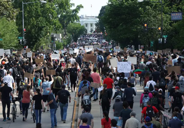 Protesters approach the White House on Tuesday evening