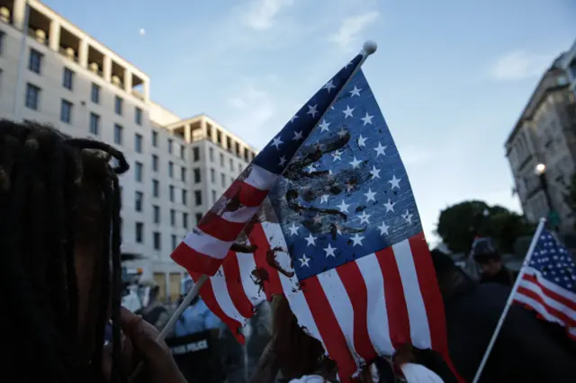 Security forces block the road as protesters gather near Lafayette Park ahead of President Trump's trip to St. John's Church in Washington