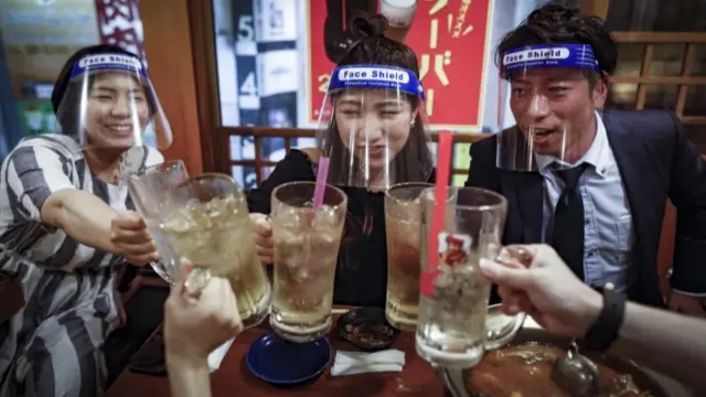 People with face shields in a Tokyo bar