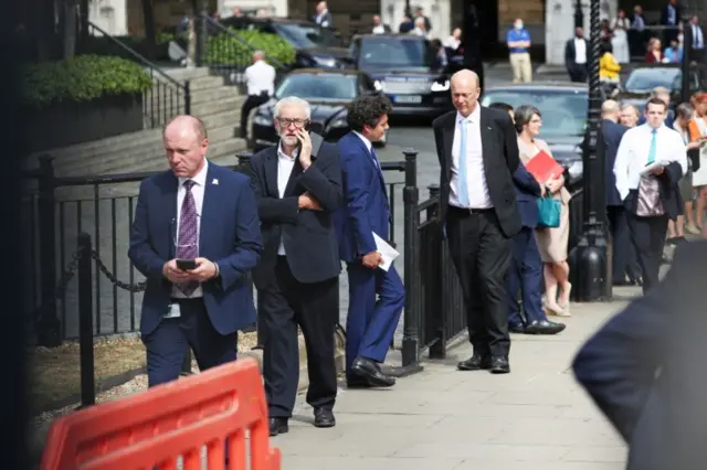 MPs queue up outside the Houses of Parliament to vote in the Commons