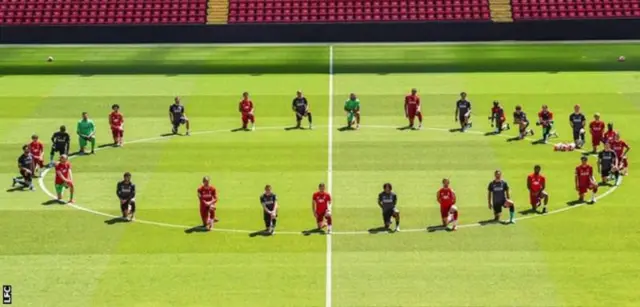 Liverpool players take a knee during training