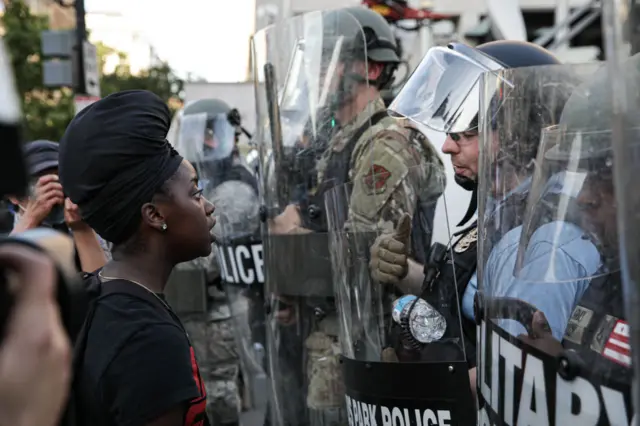 Security forces block the road as protesters gather near Lafayette Park