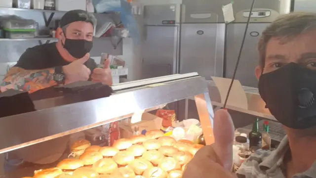 Two volunteers preparing food