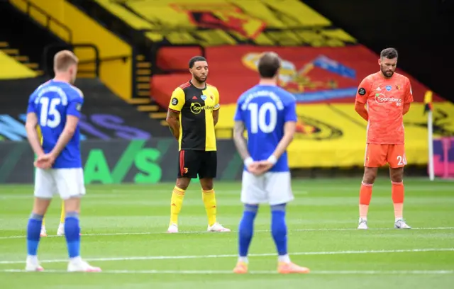 Players take part in a minute's silence