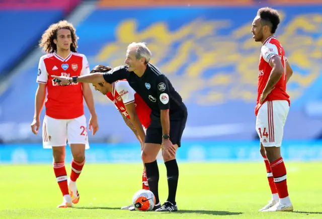 Referee Martin Atkinson awards Arsenal a freekick as Pierre-Emerick Aubameyang of Arsenal prepares to take it